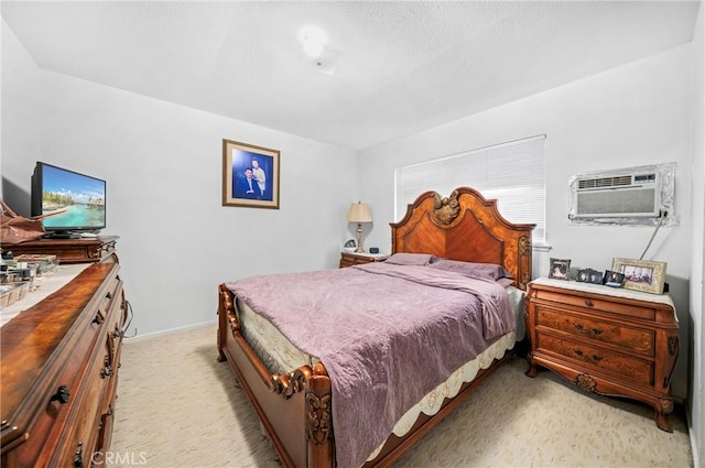 bedroom with light colored carpet and an AC wall unit