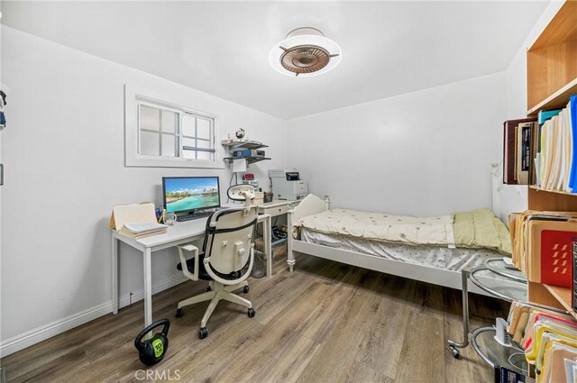 home office with wood finished floors and baseboards
