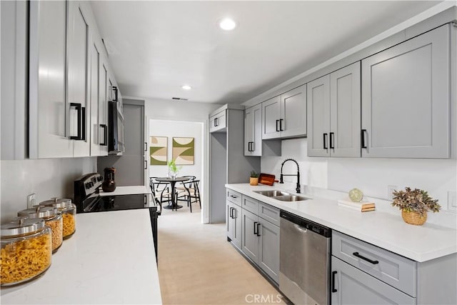 5301 Balboa Blvd Unit M4, Encino, CA 91316 - kitchen with stainless steel dishwasher, a sink, gray cabinets, range with electric stovetop, and light countertops