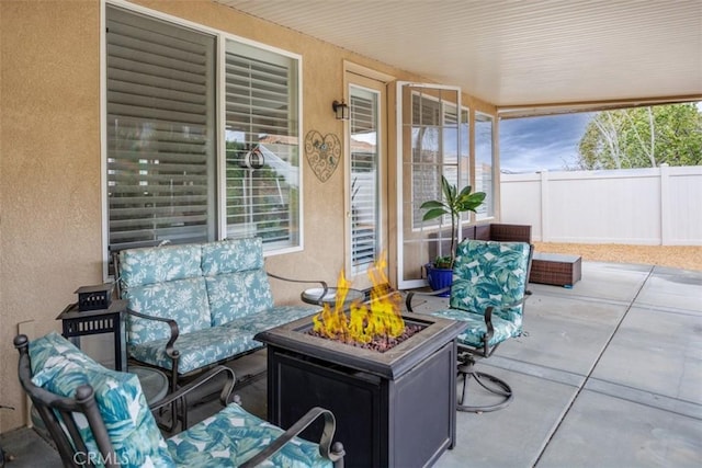 view of patio featuring fence and an outdoor fire pit