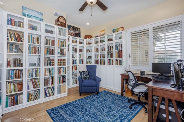 office space with a ceiling fan and wood finished floors