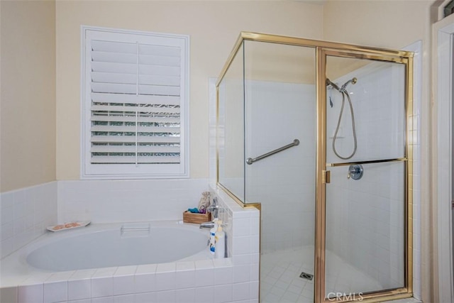 full bath with a stall shower and a garden tub