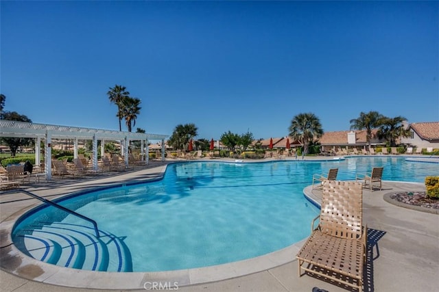 community pool featuring a pergola and a patio