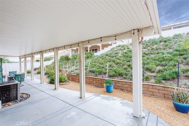 view of patio with central AC and fence