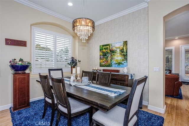 dining room with a notable chandelier, baseboards, ornamental molding, recessed lighting, and wood finished floors
