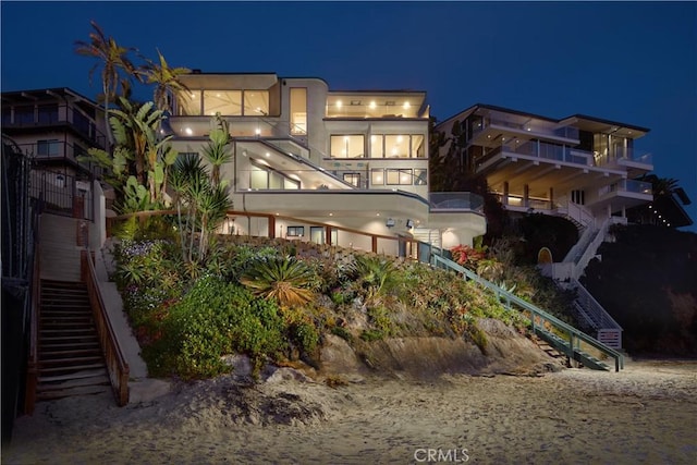 13 Lagunita Dr, Laguna Beach, CA 92651 - back of house at night with stairway and stucco siding