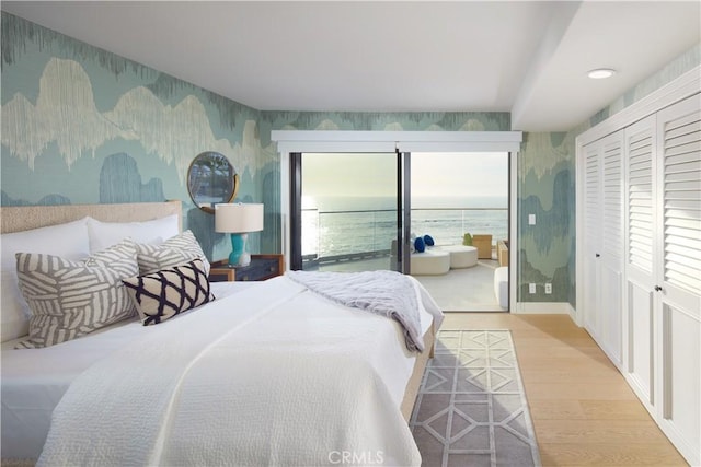 13 Lagunita Dr, Laguna Beach, CA 92651 - bedroom with wallpapered walls, wood finished floors, and a water view