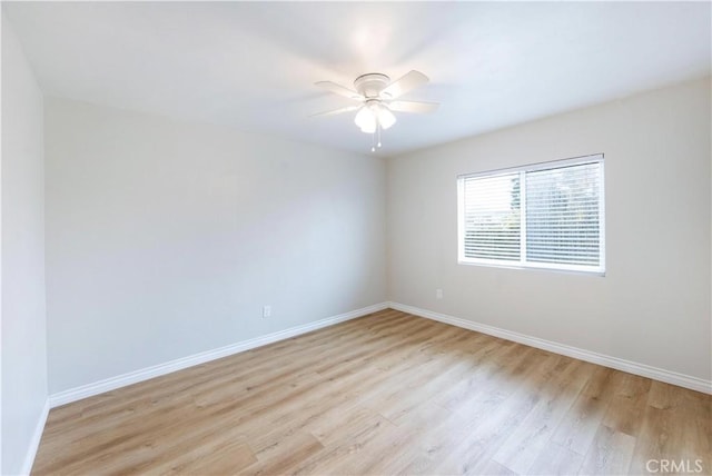 empty room with light wood-type flooring, baseboards, and ceiling fan