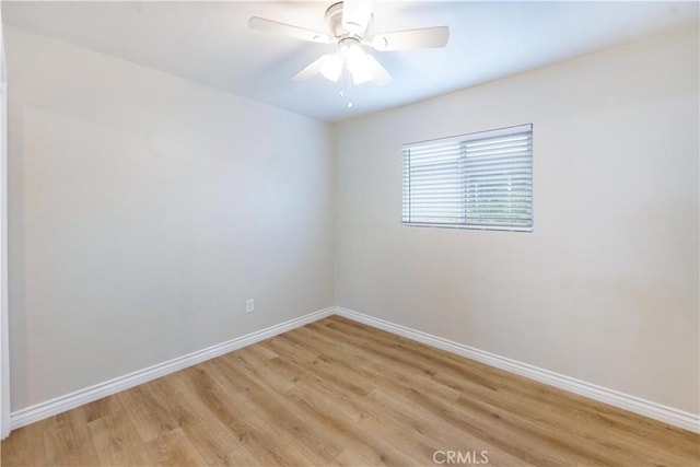 empty room with light wood-type flooring, baseboards, and ceiling fan