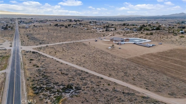 birds eye view of property featuring a rural view, a mountain view, and view of desert