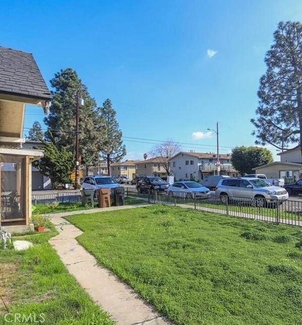 view of yard with a residential view and fence