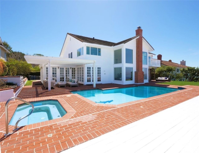 49 Country Ln, Rolling Hills Estates, CA 90274 - back of house with an outdoor pool, a chimney, an in ground hot tub, a pergola, and a patio area