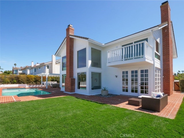 49 Country Ln, Rolling Hills Estates, CA 90274 - back of property with a patio, french doors, a lawn, a balcony, and a chimney