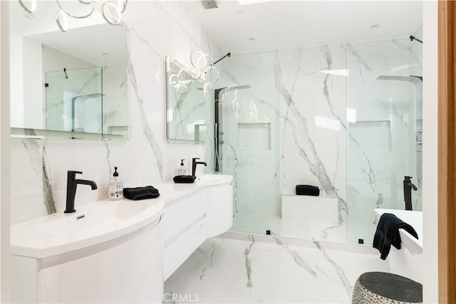 full bathroom with a marble finish shower, marble finish floor, stone wall, and a sink