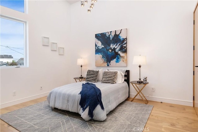 bedroom featuring light wood-style floors and baseboards