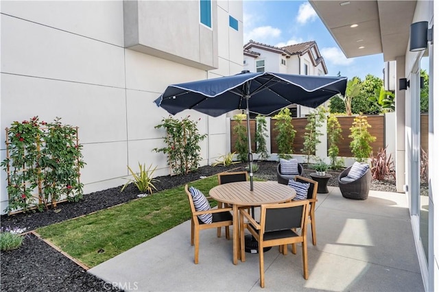 view of patio / terrace with outdoor dining area and fence