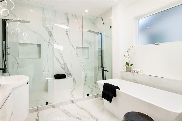 full bathroom with a freestanding tub, marble finish floor, recessed lighting, a marble finish shower, and vanity