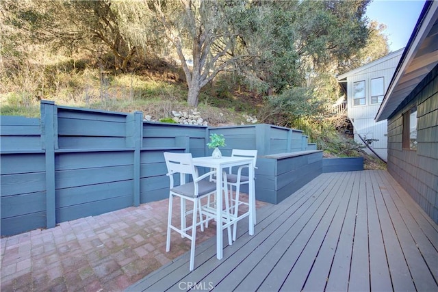 deck with outdoor dining area