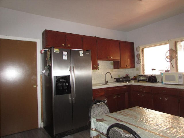 2956 W 15th St, Los Angeles, CA 90006 - kitchen with a sink, white microwave, dark wood-type flooring, backsplash, and stainless steel fridge