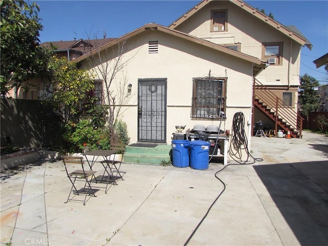 2956 W 15th St, Los Angeles, CA 90006 - back of property featuring stucco siding, stairway, and a patio