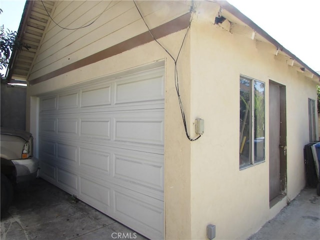 2956 W 15th St, Los Angeles, CA 90006 - view of side of property with stucco siding and a garage