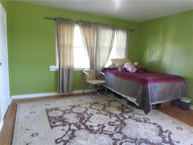 2956 W 15th St, Los Angeles, CA 90006 - bedroom with multiple windows, wood finished floors, and baseboards
