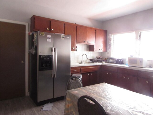 2956 W 15th St, Los Angeles, CA 90006 - kitchen with stainless steel fridge, a sink, light wood-type flooring, white microwave, and light countertops