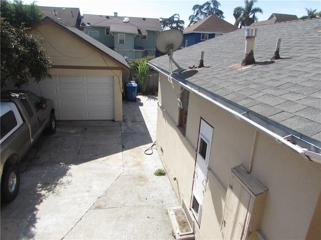 2956 W 15th St, Los Angeles, CA 90006 - details featuring concrete driveway, stucco siding, and a shingled roof