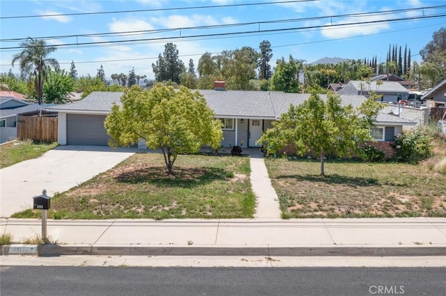 11911 Ivy Ln, Moreno Valley, CA 92557 - obstructed view of property featuring concrete driveway and a garage