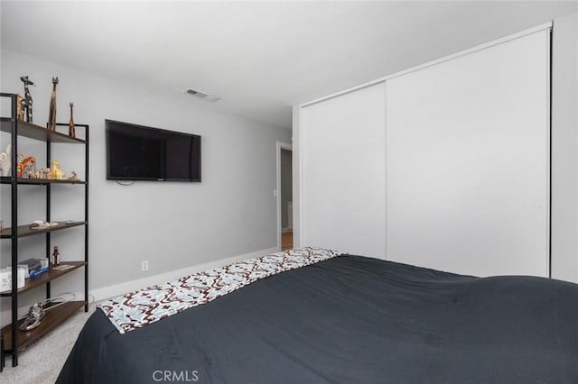 11911 Ivy Ln, Moreno Valley, CA 92557 - bedroom featuring a closet, carpet, and baseboards