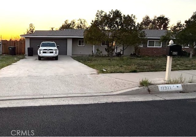 11911 Ivy Ln, Moreno Valley, CA 92557 - single story home featuring concrete driveway, a garage, and a lawn