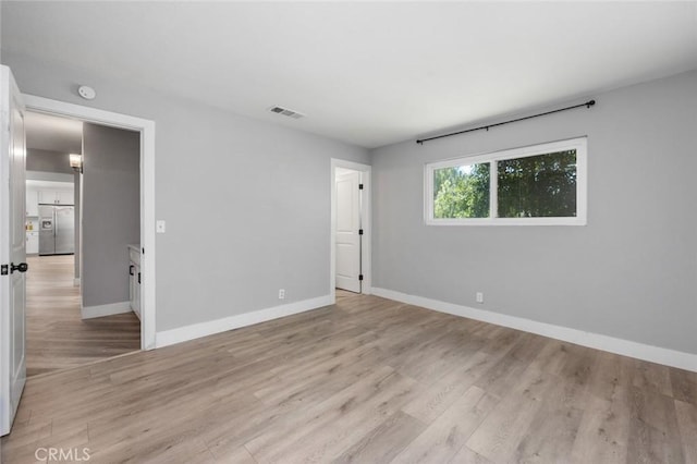 11911 Ivy Ln, Moreno Valley, CA 92557 - spare room with baseboards, light wood-style flooring, and a smoke detector