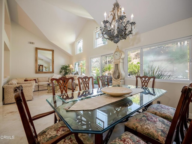dining room with an inviting chandelier, visible vents, and high vaulted ceiling