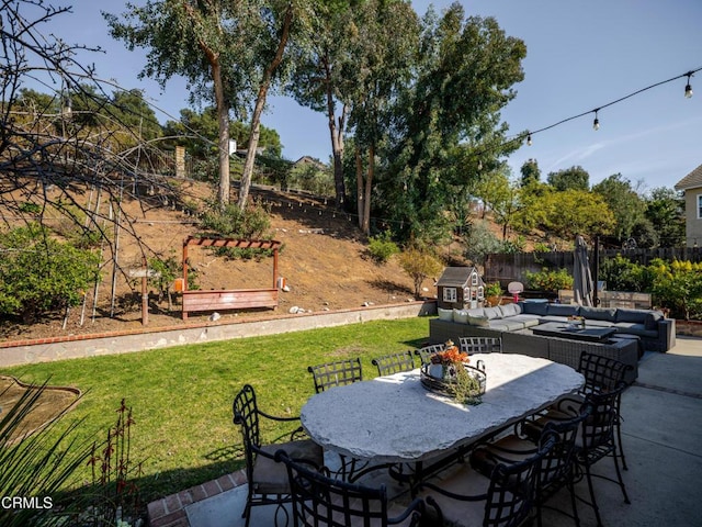 view of patio featuring outdoor dining area, fence, and an outdoor hangout area