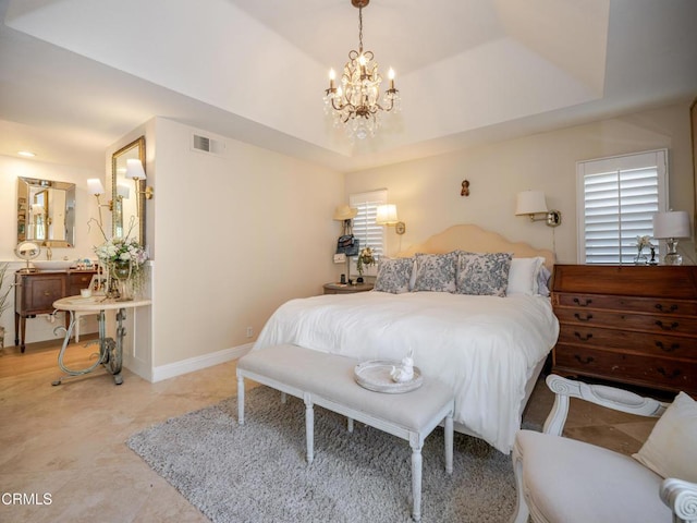 bedroom featuring a tray ceiling, visible vents, baseboards, and an inviting chandelier