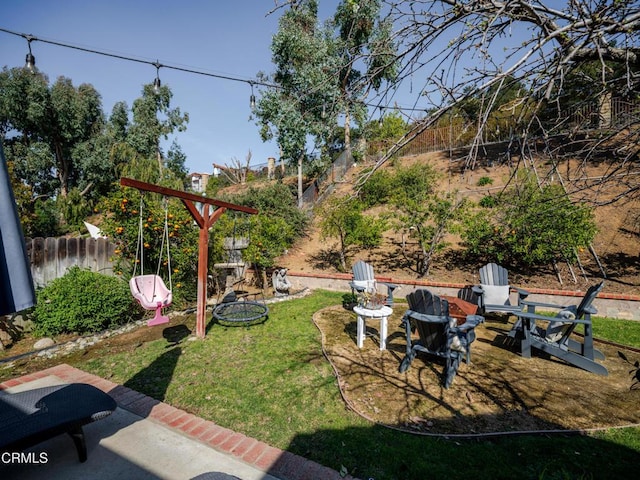 view of yard featuring a patio area, an outdoor fire pit, and fence