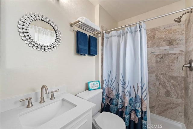 full bath featuring vanity, toilet, and tiled shower