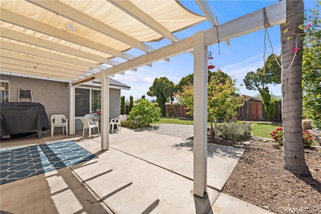 view of patio / terrace with a fenced backyard, a pergola, and a grill