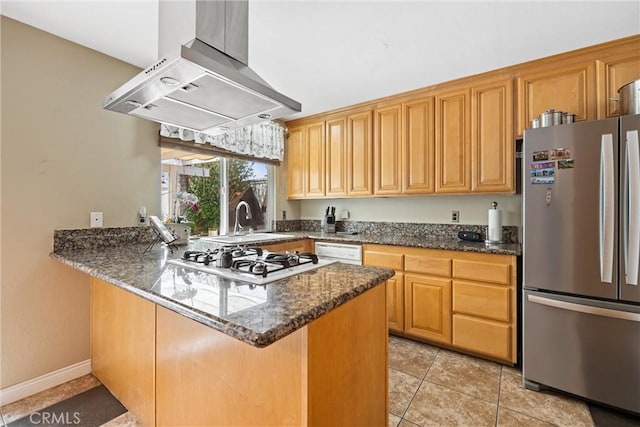 kitchen with a sink, dark stone countertops, a peninsula, white appliances, and extractor fan