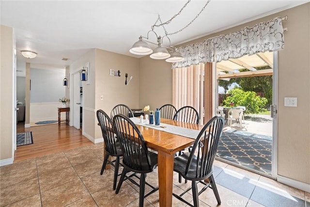 dining area with light tile patterned flooring and baseboards