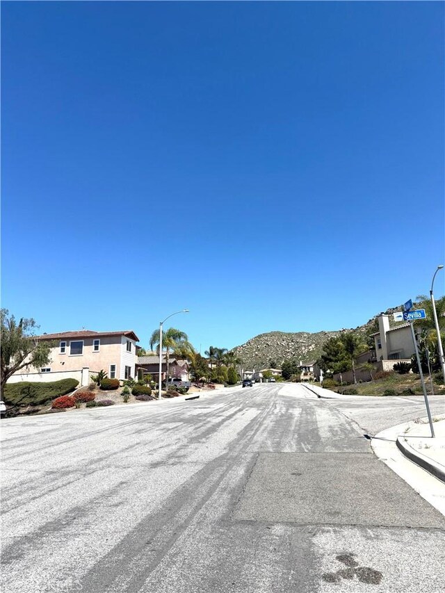 28764 Avalon Ave, Moreno Valley, CA 92555 - view of asphalt street featuring street lighting, a mountain view, and curbs