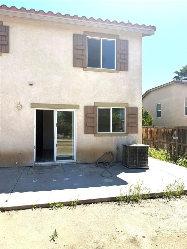 28764 Avalon Ave, Moreno Valley, CA 92555 - rear view of house with central AC, a patio, stucco siding, and fence