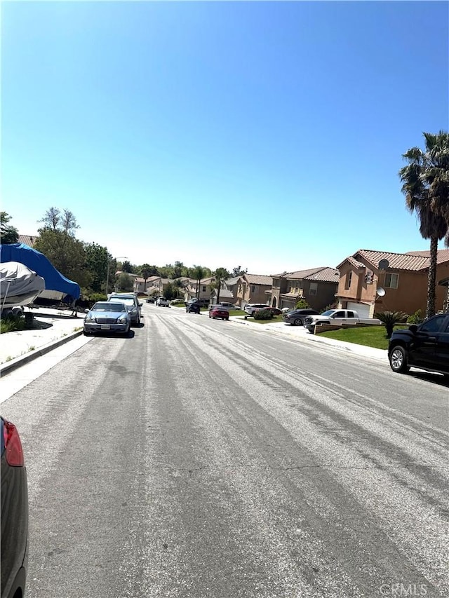 28764 Avalon Ave, Moreno Valley, CA 92555 - view of asphalt road with a residential view and curbs
