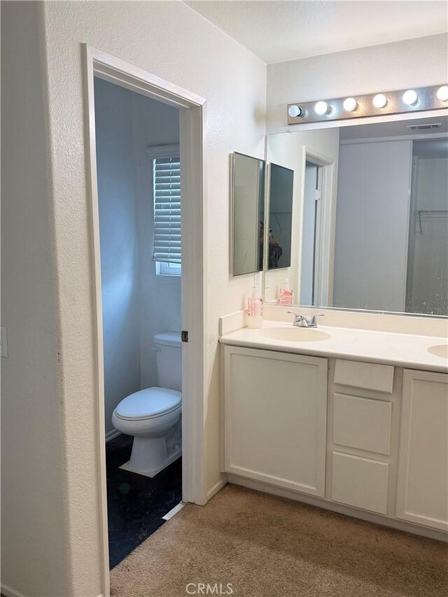 28764 Avalon Ave, Moreno Valley, CA 92555 - full bathroom featuring toilet, double vanity, and carpet floors