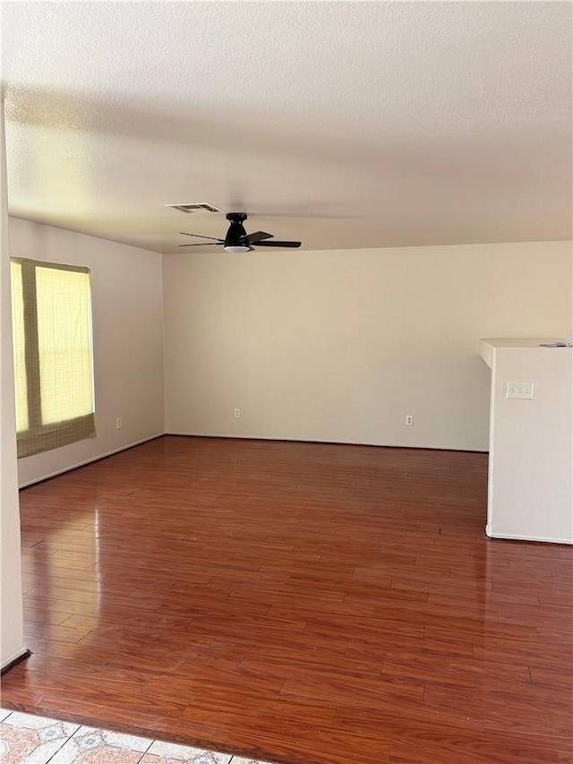 28764 Avalon Ave, Moreno Valley, CA 92555 - empty room with wood finished floors, a ceiling fan, and a textured ceiling