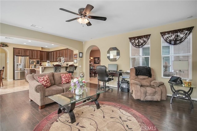 31973 Wildwood Ct, Temecula, CA 92592 - living room featuring arched walkways, wood finished floors, ceiling fan, and baseboards