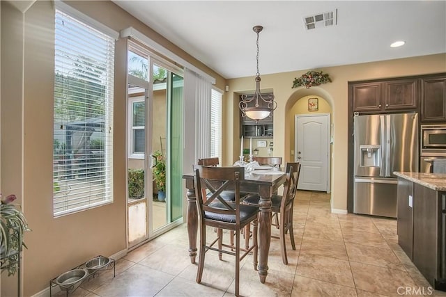31973 Wildwood Ct, Temecula, CA 92592 - dining space featuring baseboards, light tile patterned floors, recessed lighting, and arched walkways