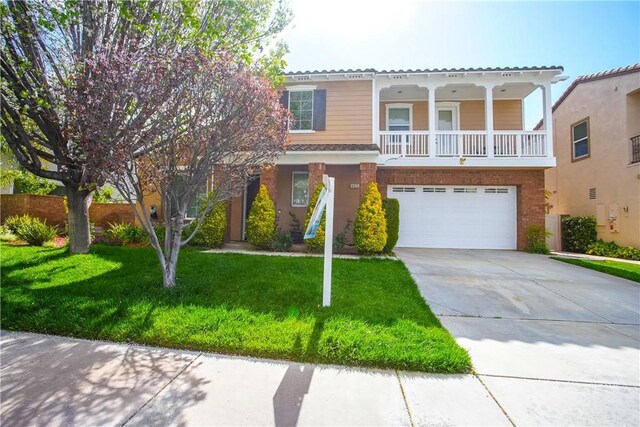 31973 Wildwood Ct, Temecula, CA 92592 - view of front of property with a garage, concrete driveway, a front lawn, and brick siding