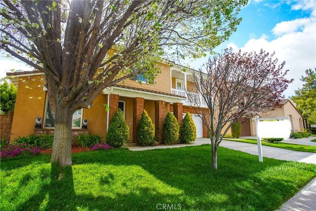 31973 Wildwood Ct, Temecula, CA 92592 - view of front of property featuring driveway, an attached garage, a front lawn, and brick siding