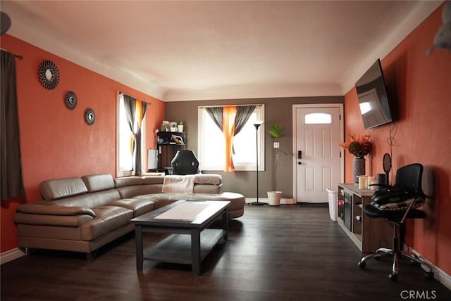 living room with baseboards and dark wood-type flooring